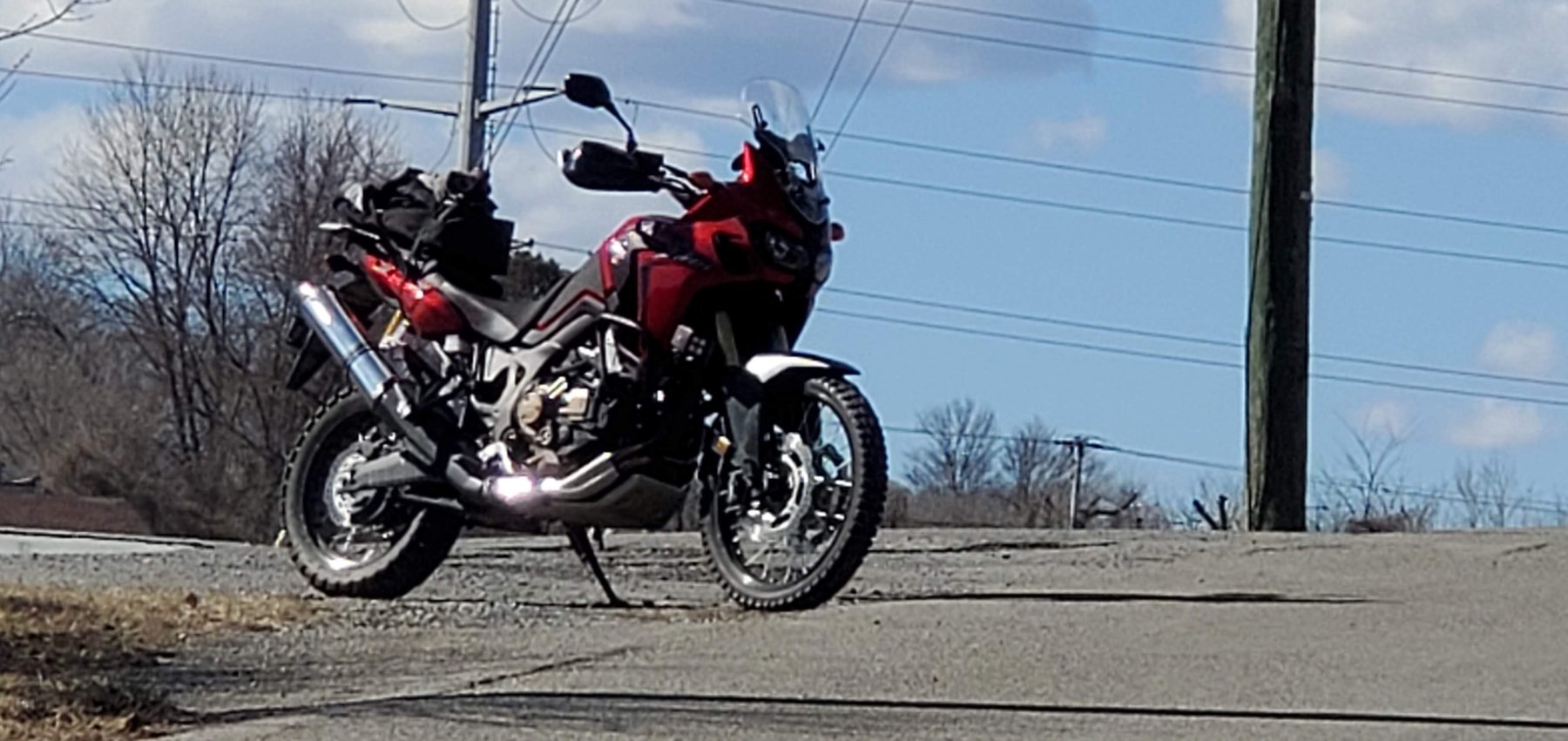 Red adventure motorcycle parked roadside
